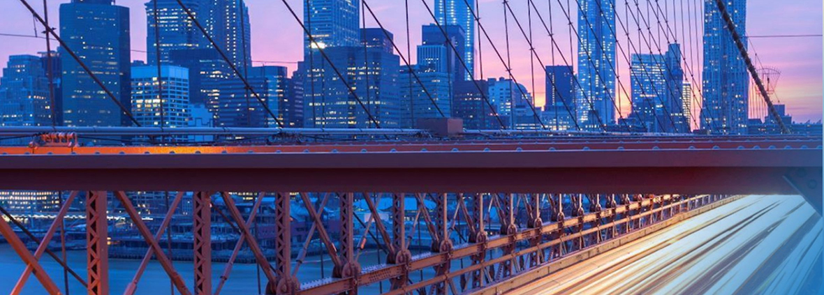 Bridge at sunset with a city view, GM Investors